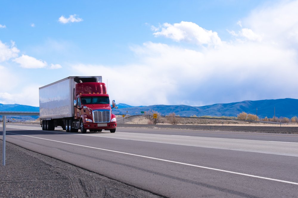 Big,rig,american,bonnet,powerful,red,semi,truck,with,refrigerated