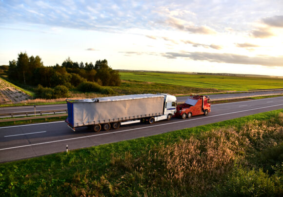 Heavy,recovery,truck,tows,a,semitrailer,truck,on,highway.,emergency